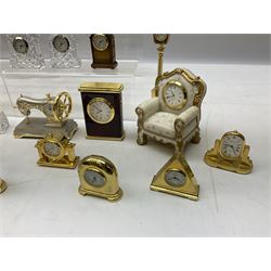 Collection of miniature clocks, predominantly with quartz movements, to include example modelled as an armchair, Edinburgh crystal glass example, clock modelled as a flower, sewing machine etc