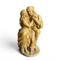 Composite garden statue group of Romeo and Juliet embracing in Medieval dress, surmounted on a naturalistic foliate base, in antique distressed glazed finish