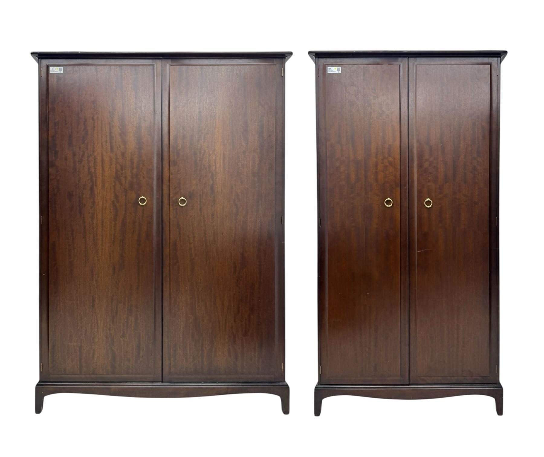 Stag Minstrel - pair of mahogany double wardrobes, comprising a larger wardrobe with a shelf and hanging rail behind two panelled doors (W127cm, D59cm, H177cm); and a smaller wardrobe enclosing a single hanging rail (W96cm, D59cm, H177cm), both finished with projecting cornices and raised on bracket feet



