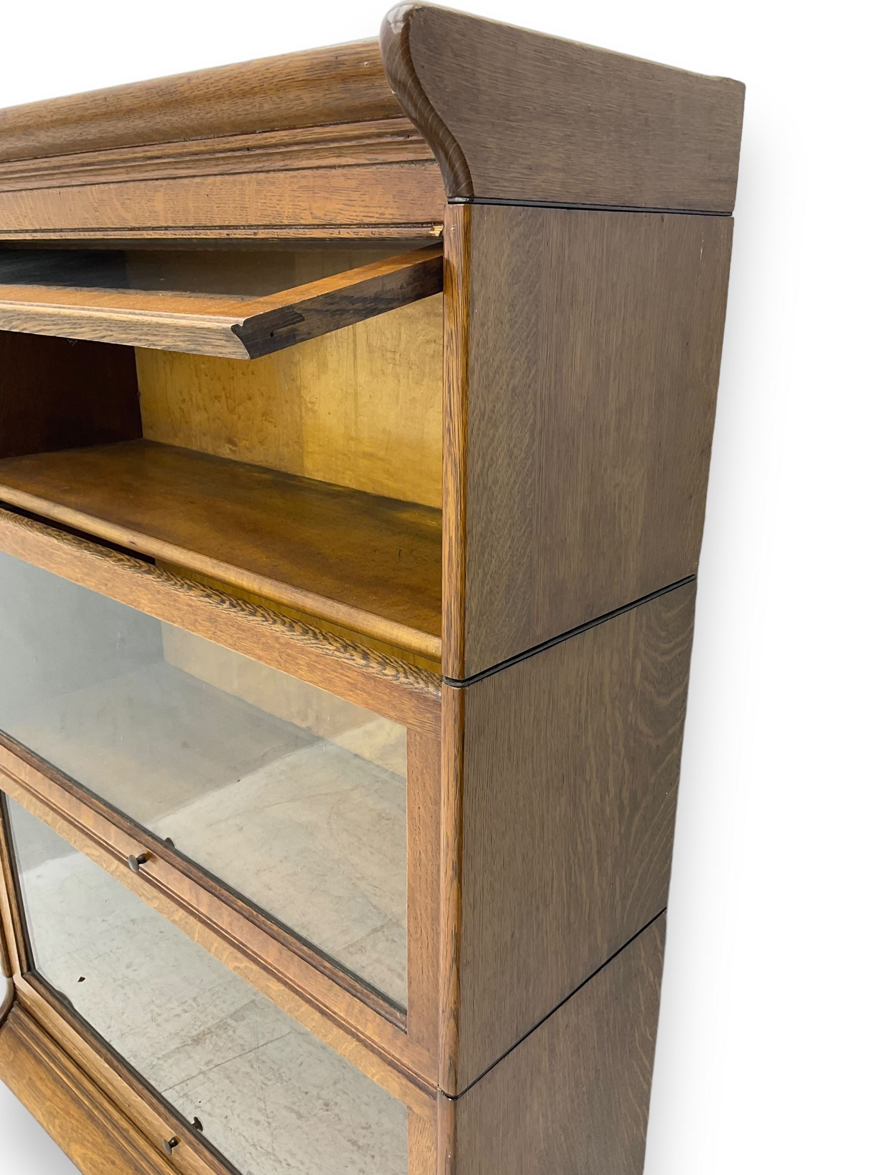 Early 20th century oak three-tier stacking library bookcase, enclosed by hinged and sliding glazed doors