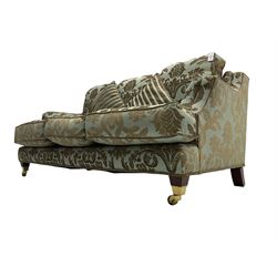 Wade - 'Kempston' three seat sofa, upholstered in chenille fabric with brocade pattern, raised on mahogany finish square tapering block feet with heavy brass castors