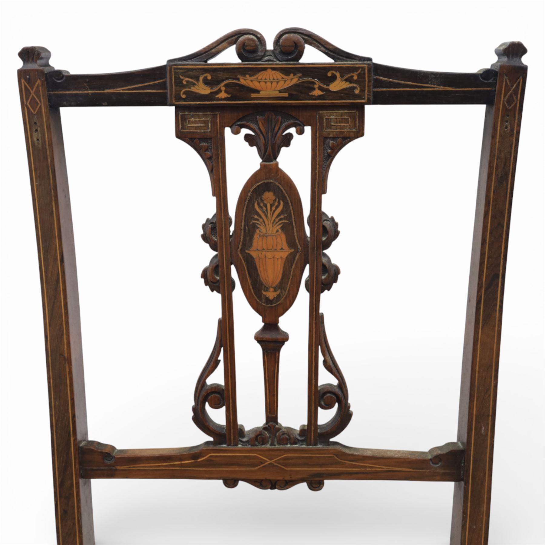 Quality Edwardian seven piece inlaid salon suite, comprising three seater settee, pair of arm chairs and four chairs with pierced splat backs, upholstered in pale pink fabric, inlaid with flowering urns, upon tapering legs with spade feet and castors