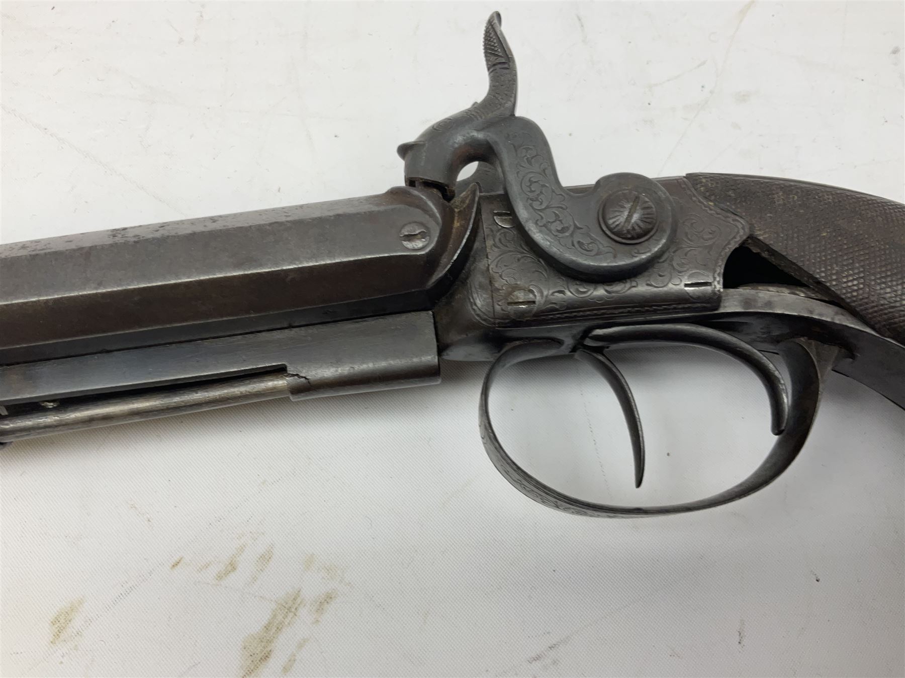 Early 19c percussion double barrel Howdah pistol by J. Blisset London, c1840s, approximately 50 calibre, 10.5cm octagonal monobloc barrels with captive swivel ramrod under, finely chequered walnut stock, engraved hammers, lock plates, tang and trigger guard, butt plate with hinged cap compartment, vacant white metal oval escutcheon L25.5cm overall