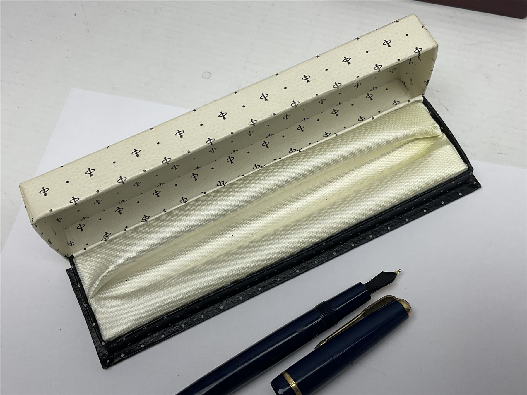 Three fountain pens, to include Conway Stewart 'Dinkie 550' and 'Conway 57' and a Parker 'Slimfold', all with 14ct gold nibs, together two roller ball pens, including a Parker example and a Swarovski Crystal paperweight