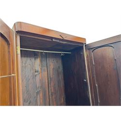 Victorian figured walnut single wardrobe, the moulded cornice with a central diamond motif over a pair of arched panelled doors with striking book-matched veneers, enclosing a fitted interior with hanging rail and hooks, on a plinth base