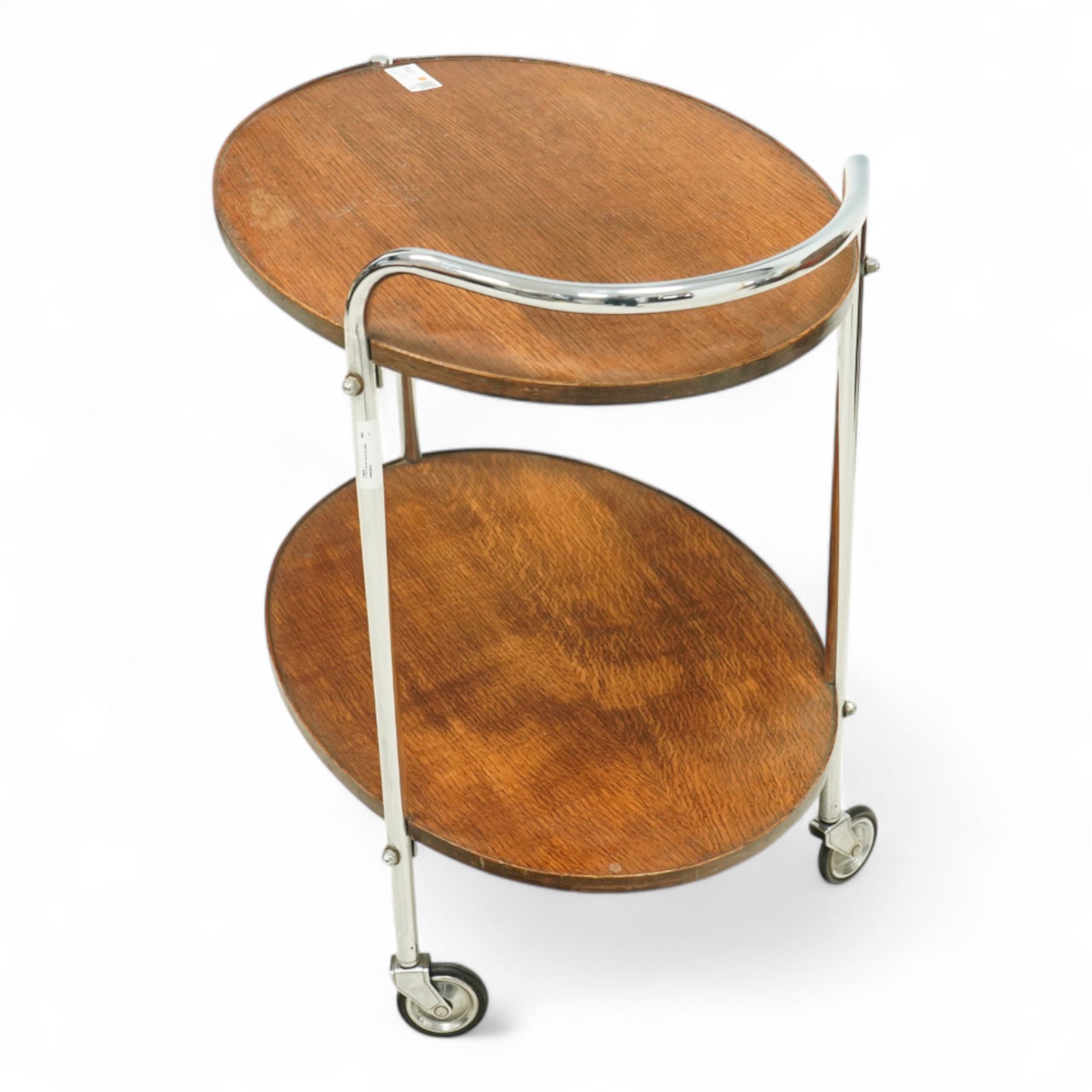 Mid-century oak and chromed metal drinks trolley, twin tiered oval form with rounded edges, chromed tubular supports with integrated handle 