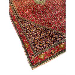 Persian Bijar red and blue ground rug, central panel decorated with tree of life and flower head motifs, decorated all-over with Herati motifs, triple band band border decorated with stylised plant motifs