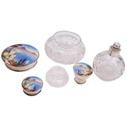 1920's three piece silver mounted cut glass dressing table set, comprising two jars of squat circular form with silver covers, and a globular bottle with silver collar, glass stopper and silver cover, each cover inset with hand painted enamel panels depicting the bay of Naples with Mount Vesuvius in the background, each signed App, hallmarked Daniel Manufacturing Company, Birmingham 1929, largest example H10.5cm smallest H4.5cm