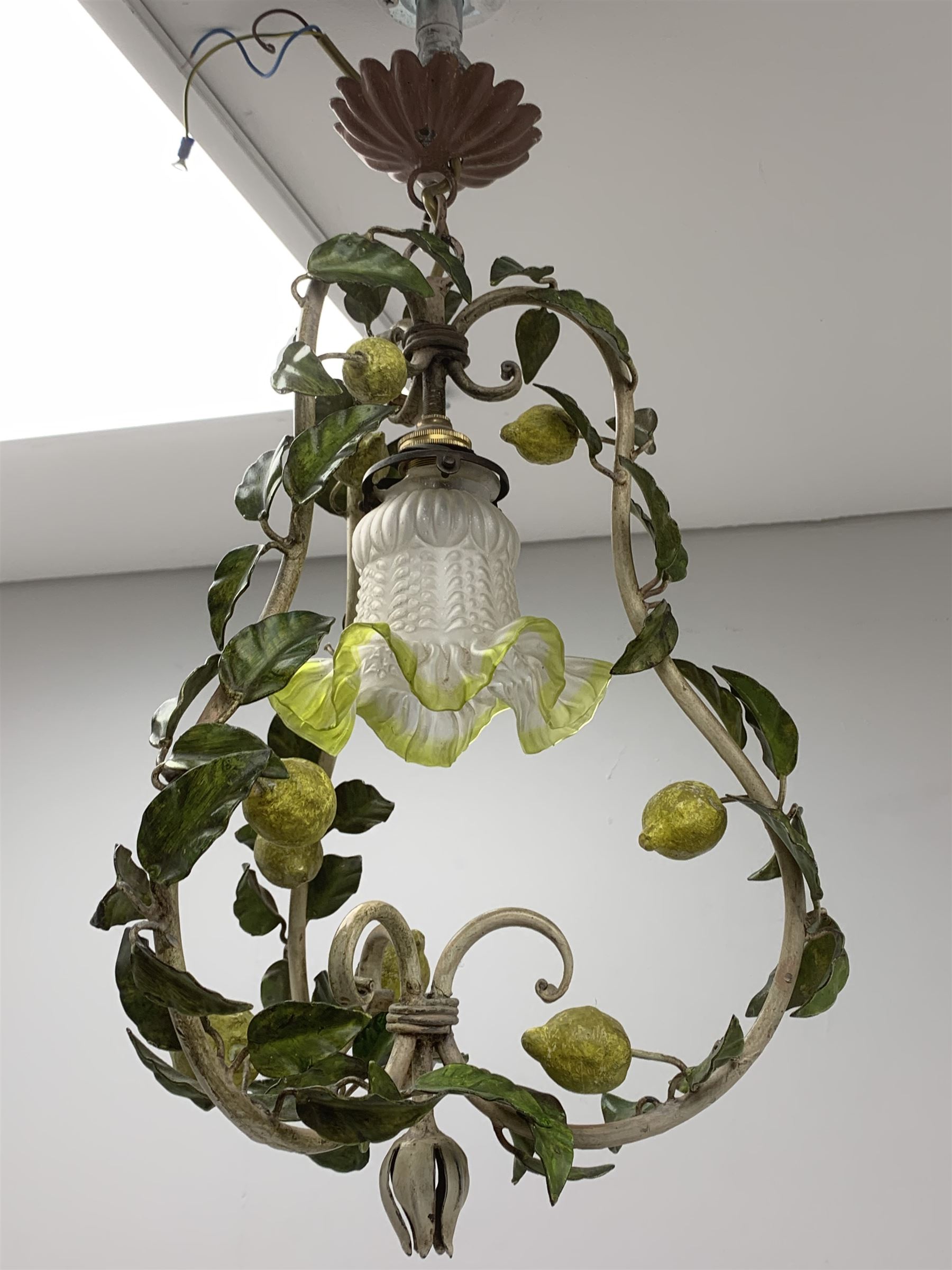 A toleware light fitting modelled with fruiting lemon vines around a frilled glass shade, approximately H48cm
