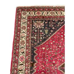 Persian Hamadan rug, red ground lozenge on dark field, decorated all-over with small animal and bird motifs, repeating guarded border