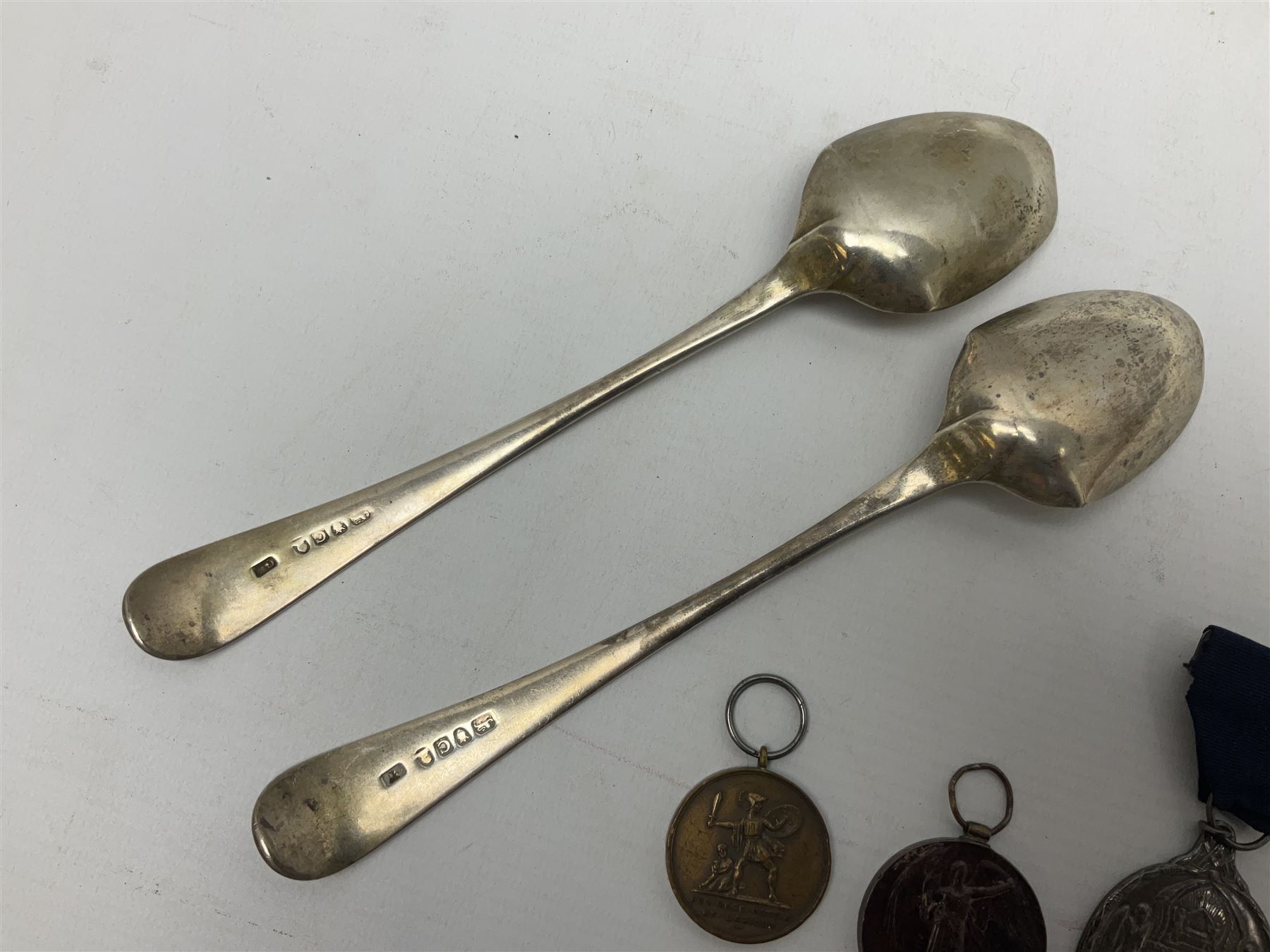 Two silver Georgian tablespoons, approximate total weight 3.36 ozt (104.7 grams), together with Great War Peace Medal 1919 and two others 