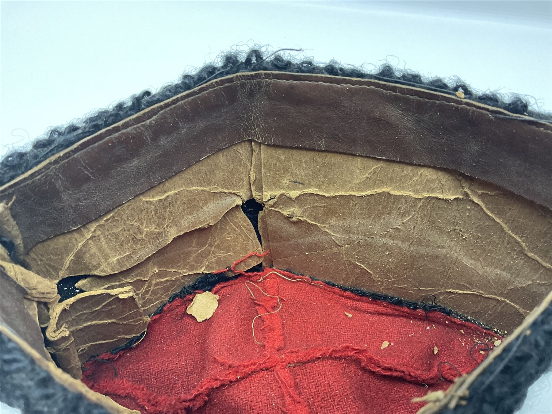 WW2 German small size Balkan style hat with 'SS' metal badges; red cloth top and flash to front with black persianelle type sides; lined in brown card with leather sweatband