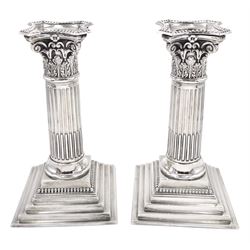 Pair of late Victorian silver Corinthian column candlesticks, each with removable beaded nozzle upon foliate capital, fluted column and filled stepped base, hallmarked James Charles Jay, London 1895, H16cm