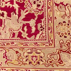 Large Persian Savonnerie-inspired style flatweave kilim, crimson field with central stylized palmette medallion with bold scrolling vinery and angular floral motifs between multiple guard stripes, rendered in tones of soft cream, pale sage, and muted terracotta, with fringe ends 