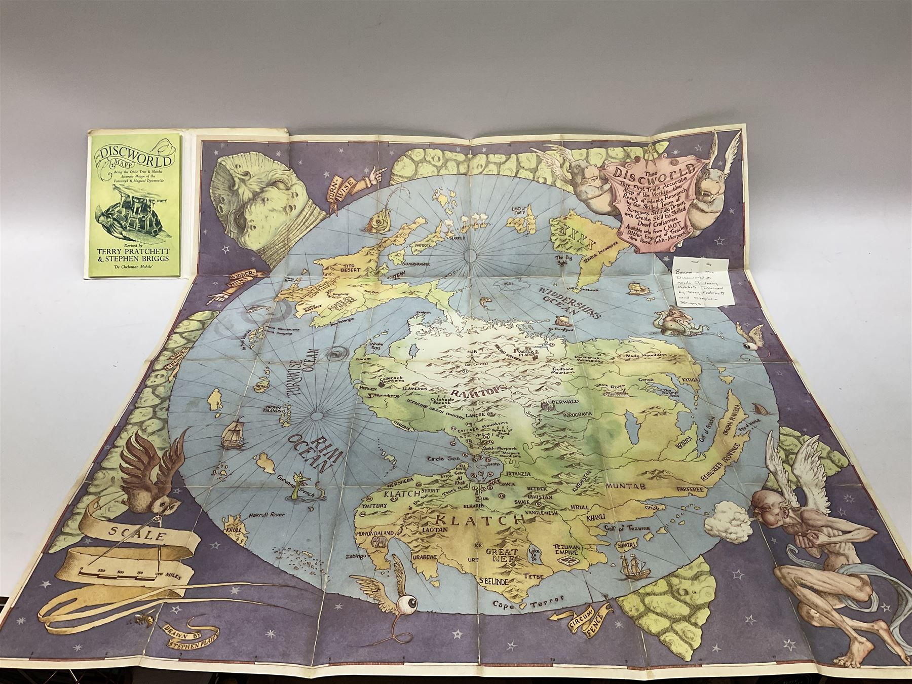 Terry Pratchett Discworld figures, designed by Clarecraft, comprising Death and Granny Weatherwax, DW90, Deathhead DWE8, Dried-frog pill box, boxed, DW63, Death as Beau Nidle, boxed, DW88, Agnes Nitt DW68, Detritus, DW22, Bonsai mountain, DW78, Volcanic bonsai mountain, boxed, DW79, Bonsai mountain valley, DW80, together with the Discworld mapp, and a collection of Terry Pratchett cards.  