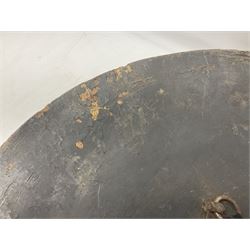 Indian black lacquered hide shield/dhal, of circular convex form fitted at its centre with four pierced iron bosses, each of hemispherical form with wide brims, the bosses corresponding on the inside with four iron rings for enarmes D53.5cm