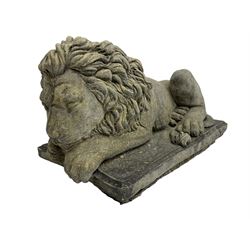 Pair of small cast stone sleeping lions, on rectangular moulded plinths