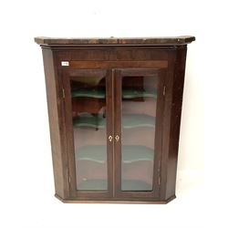 19th century mahogany hanging corner cabinet, projecting cornice, crossband and inlaid detail, two glazed doors enclosing three shaped shelves 