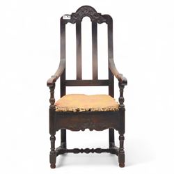 18th century oak provincial armchair, arched and carved cresting rail above triple splat back, shaped arms on turned supports, stuff-over seat upholstered in damask fabric, carved front frieze on turned legs united by stretchers