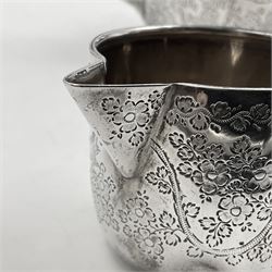 Late Victorian silver bachelors three piece tea service, comprising bullet shaped teapot, open sucrier and milk jug, each engraved with monogram surrounded by birds upon and amidst a blossoming vine, the teapot with scroll capped curved wooden handle and wooden finial to cover, hallmarked Wakely & Wheeler, London 1890, teapot including handle H12cm, sucrier H5.5cm 