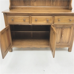 Ercol Old Colonial elm dresser, Golden Dawn finish, raised three tier plate rack above three drawers and three cupboards, stile supports, W147cm, H193cm, D52cm