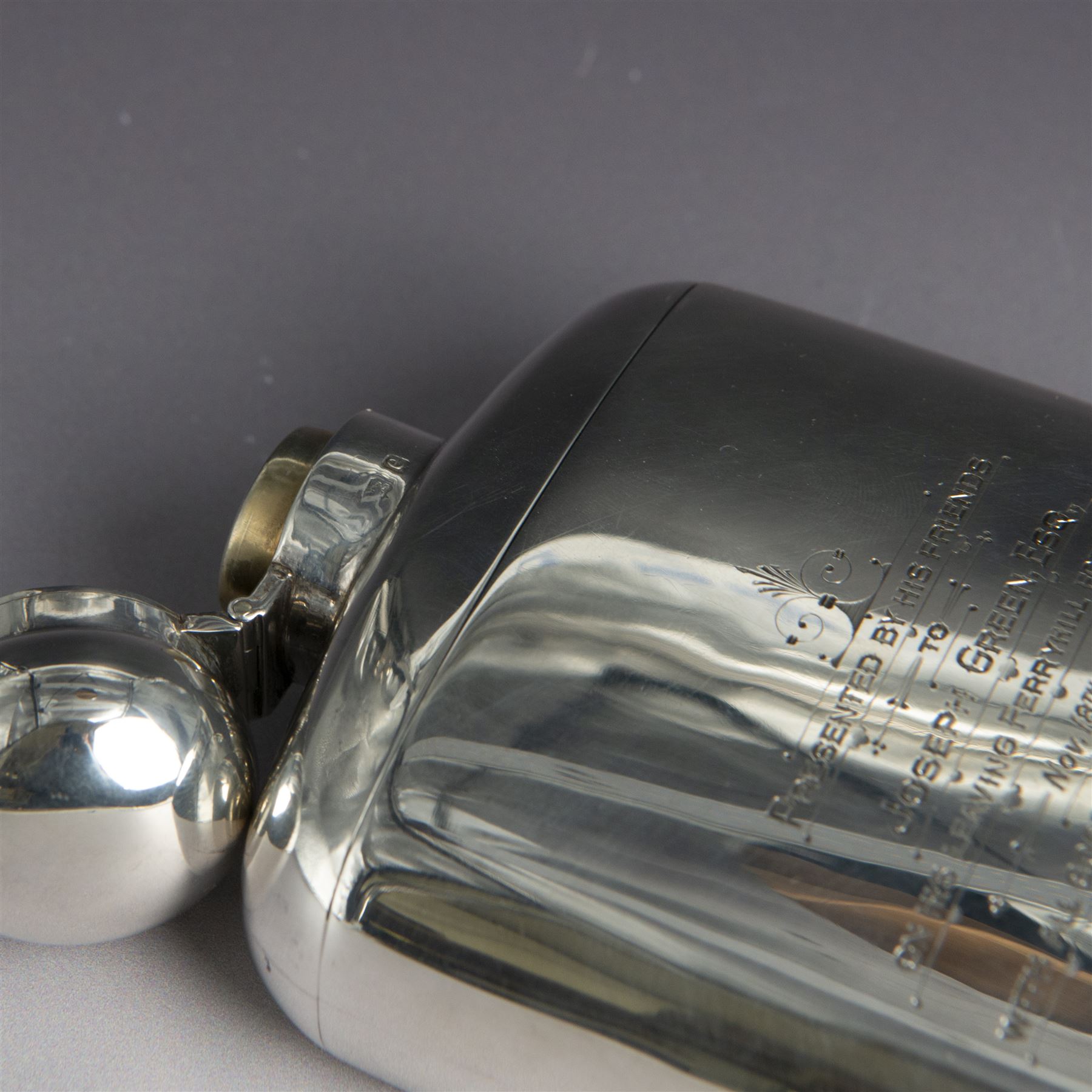 Edwardian silver hip flask, of slightly curved rectangular form, with silver body, hinged cap and removable silver cup, the cup with presentation engraving and gilt interior, hallmarked Hilliard & Thomason, Birmingham 1904, H17cm