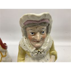 19th century and later Toby jugs comprising Staffordshire Punch and Judy jugs, Victorian 'I am on the black list' jug, two jugs in the form of Toby with a jug of beer (5)