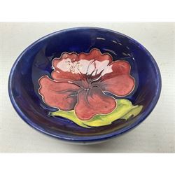 Moorcroft rectangular pin dish decorated in the Clematis pattern upon cobalt blue ground, together with a small circular footed dish decorated in the Hibiscus pattern, both with impressed marks beneath, tray L20cm (2)