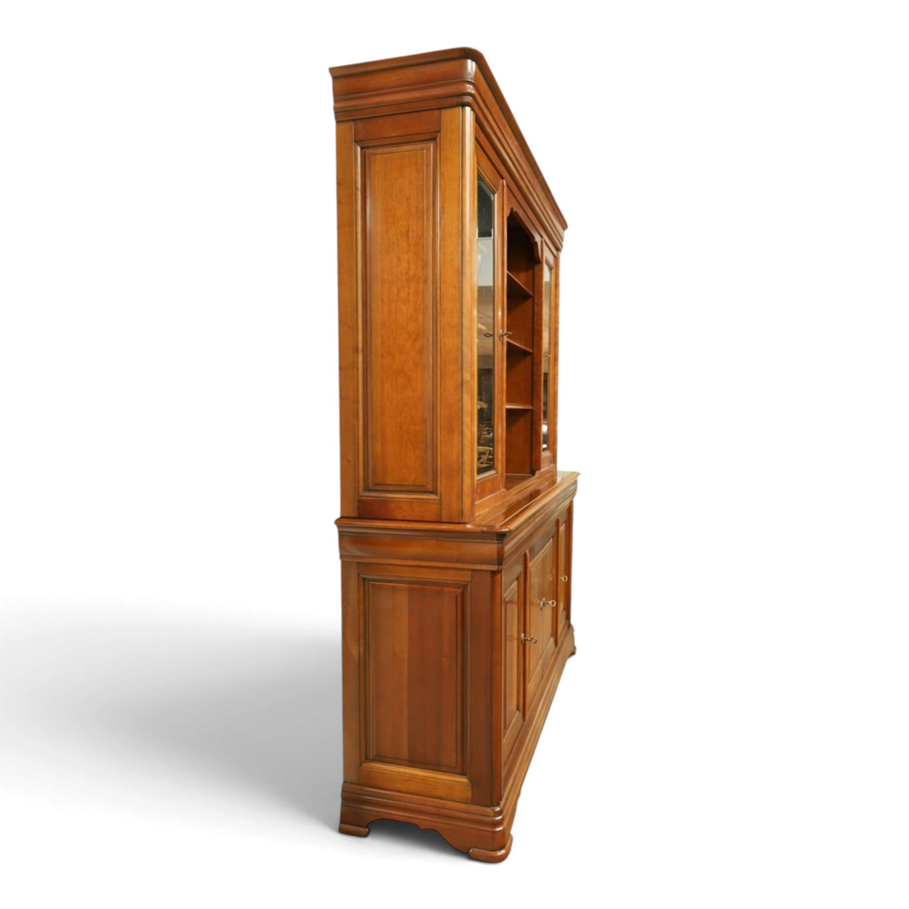 Barker & Stonehouse - large cherrywood bookcase cabinet, the moulded cornice above two glazed doors flanking an open central section, the base with three cushion drawers over four lockable panelled cupboard doors, raised on bracket feet
