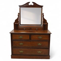 Edwardian walnut dressing chest, rectangular top surmounted by a mirror frame with shaped pediment on swing supports above two short frieze drawers over two short and three long graduated drawers fitted with brass foliate handles, raised on a plinth base