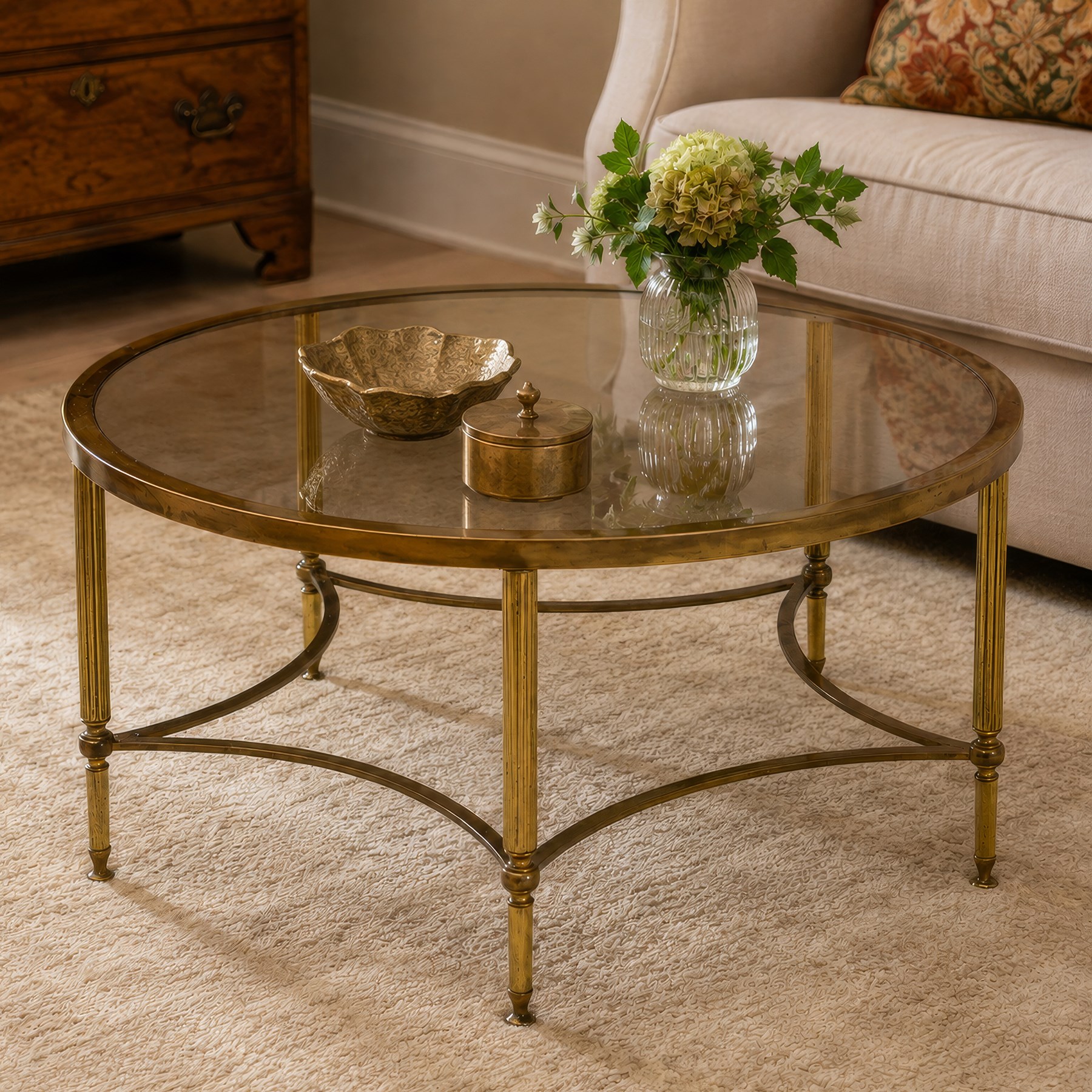 Regency style brass and glass circular table, smoked glass top mounted to a brass frame with fluted supports united by stretchers