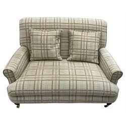 Traditionally shaped two-seat sofa, rolled back and arms, upholstered in checkered fabric, on turned front supports with brass cups and castors 
