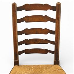 Early 19th century set of six country ladder back chairs, each with five shaped horizontal slats, woven rush seats within square frames, standing on turned forelegs united by peripheral stretchers with turned front rail
