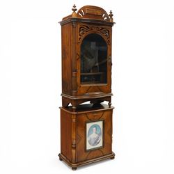 Late 19th century coin operated floor standing Polyphon, the shaped cornice marked 'Polyphon' with eleven 50cm discs in a walnut case with glazed upper section, the coin slot marked '1 Penny', the lower section with fall front for disc storage and inset with a portrait print and on compressed bun feet H230cm x W76cm x D46cm with a number of old pennies