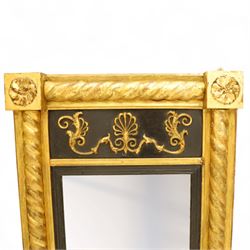 19th-century Regency-style ebonized and giltwood pier mirror, rectangular form frame with twisted rope columns on either side, ebonized frieze panel decorated with gilt applique scrollwork and central anthemion and arabesques