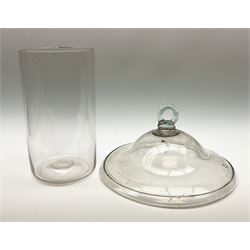 A 19th century clear glass smoke bell, of domed form with looped handle and folded rim, D25cm, together with a 19th century clear glass liner, of plain cylindrical form, H21.5cm. 