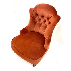 Victorian nursing chair upholstered in a buttoned terracotta fabric, turned tapering supports 