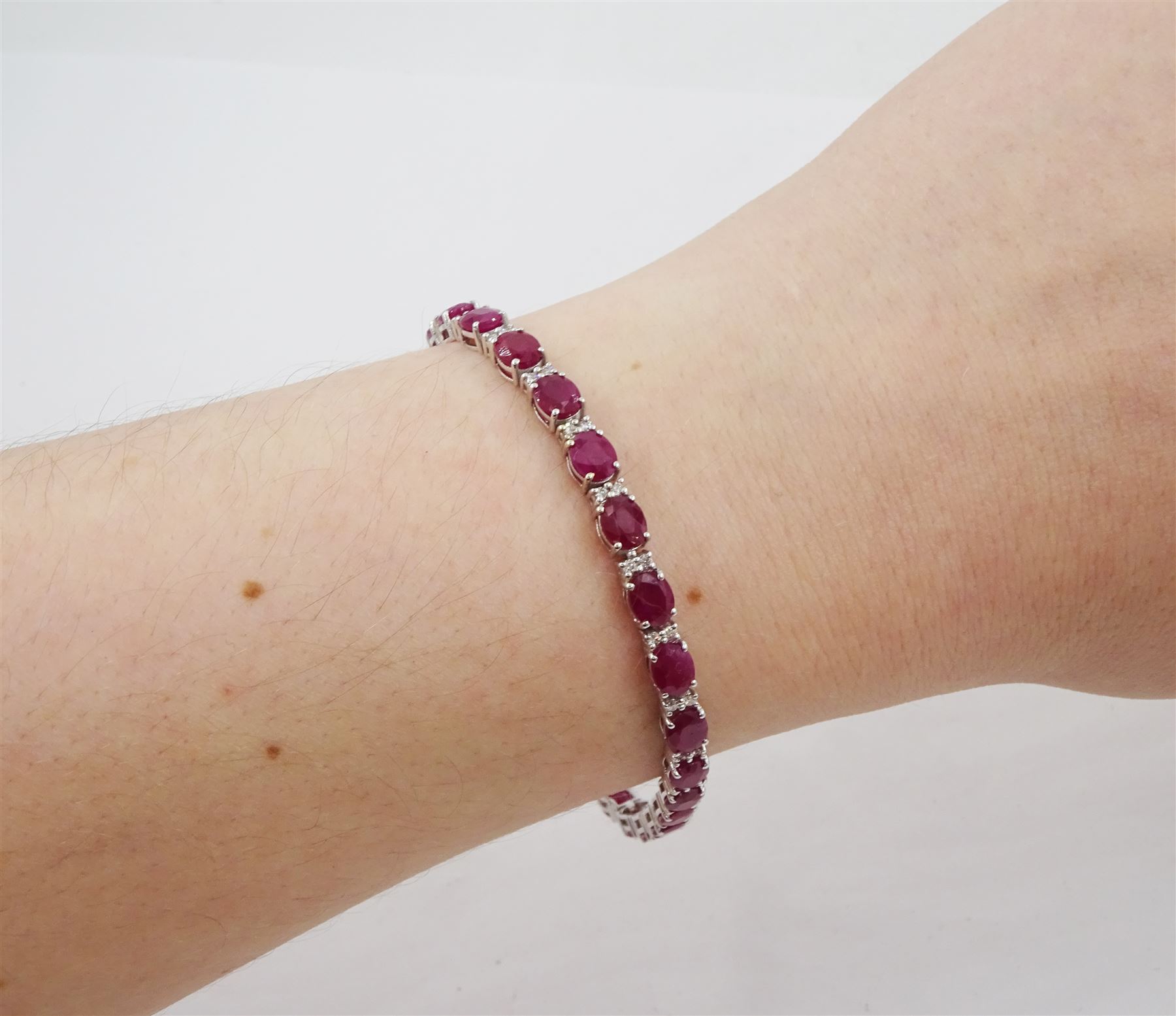 18ct white gold oval cut ruby and round brilliant cut diamond bracelet, stamped 750, total ruby weight 12.70 carat, total diamond weight 0.46 carat