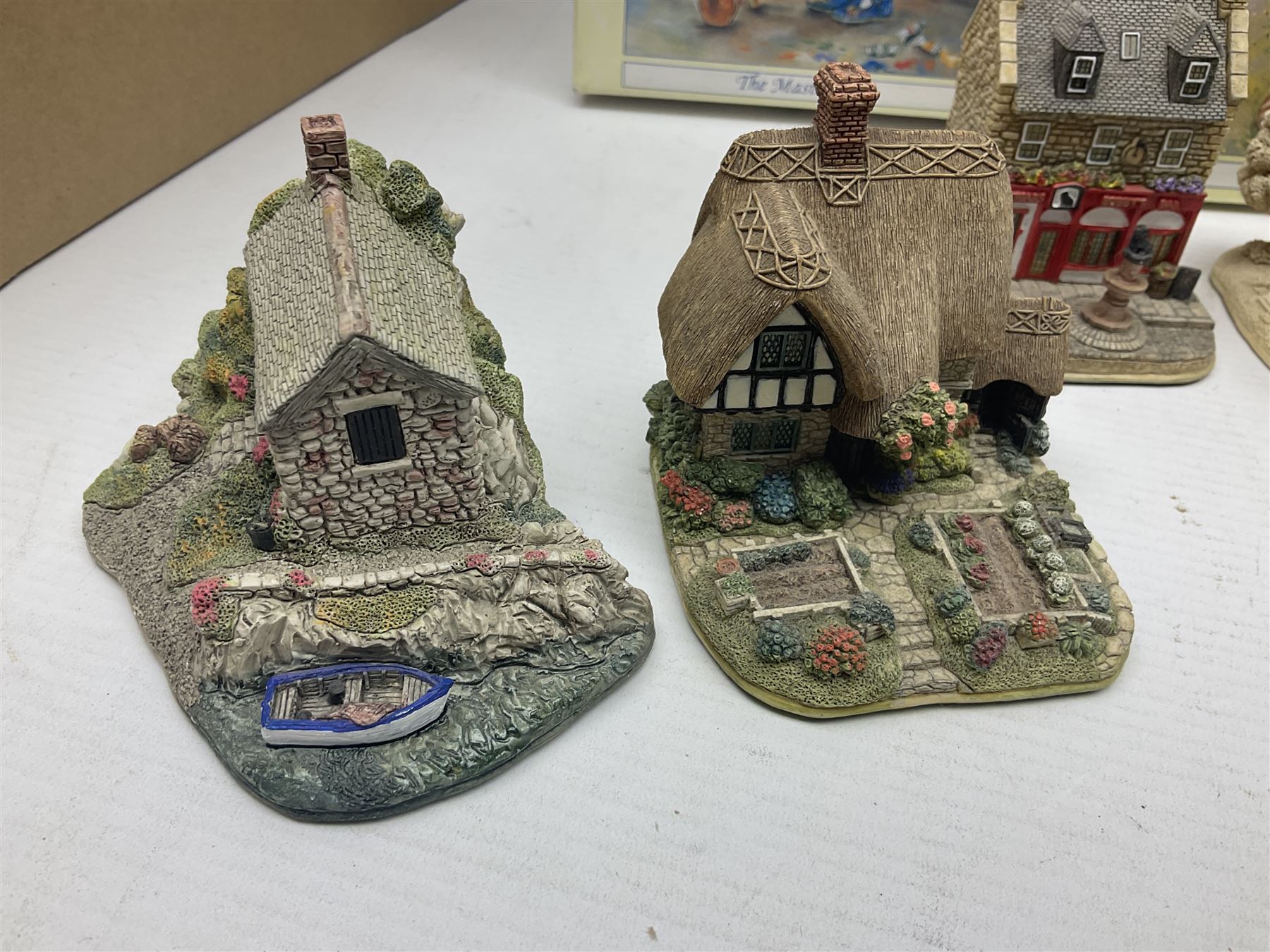 Twenty three Lilliput Lanes, including Village School, Lace's Shoe Shop, Cockles & Muscles, Scotland the Brave etc, together with The Leonardo Collection Paint Box Poppets and Gullivers World magazines 