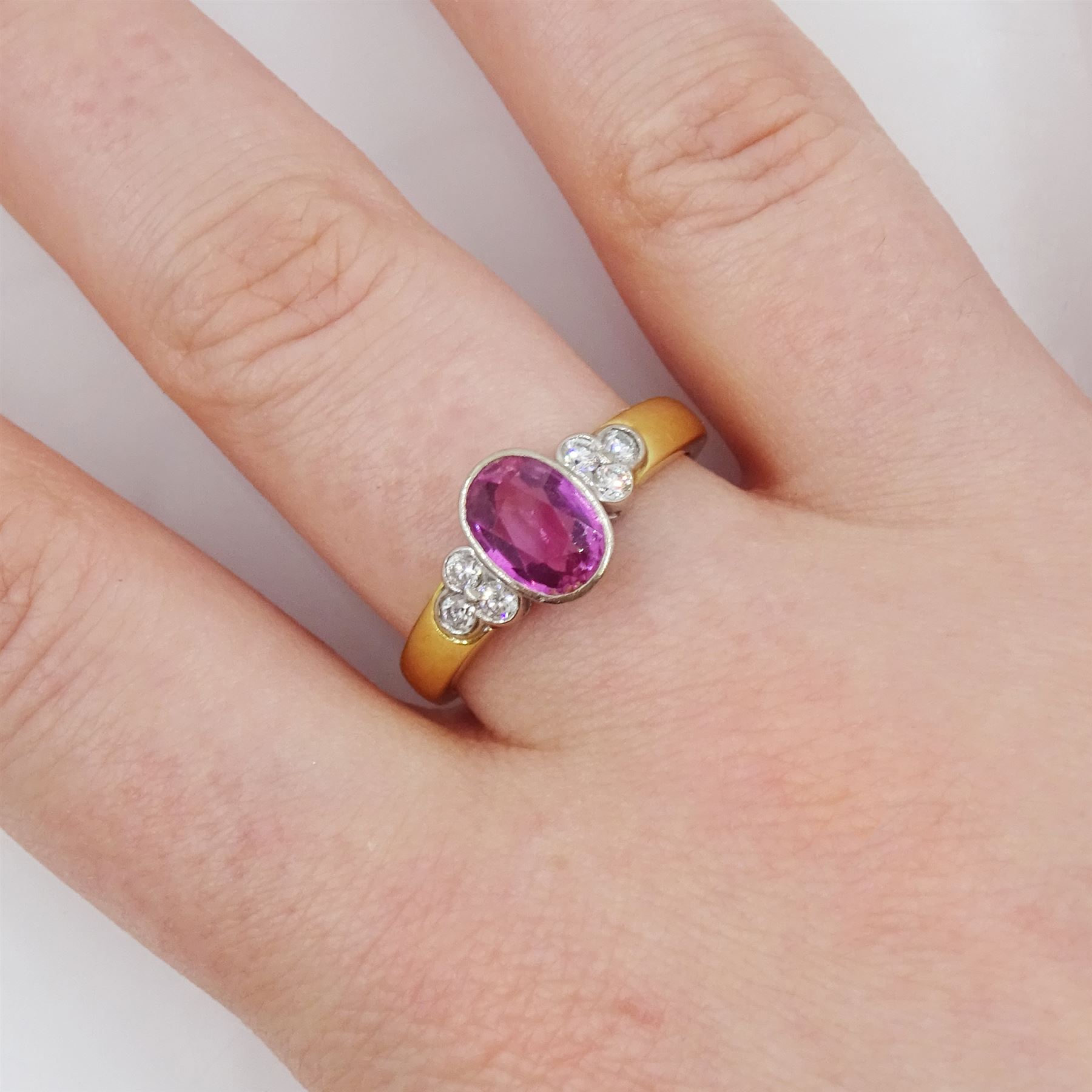 18ct gold oval cut pink sapphire and six round brilliant cut diamond ring, London 1998, sapphire approx 1.35 carat, total diamond weight approx 0.20 carat