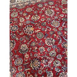 Large Fine Persian Kashan rug, red ground field decorated with large stylised flower heads, the ivory ground border with matching motifs and trailing foliage