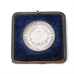 Group of early 20th century sporting medallions, fobs and badges, including two silver Inter Varsity 1/4 mile cased medallions, two silver fobs, white metal and enamel cricket fob etc, one awarded to John Barugh Fisher (1888-1924) born in Amotherby, studied at Leeds University and became doctor in 1911, later Captain John Barugh Fisher R.A.M.C., together with four early 20th century nurses badges, two for General Infirmary Leeds, three inscribed B.P. Simpson, housed in an inlaid work box