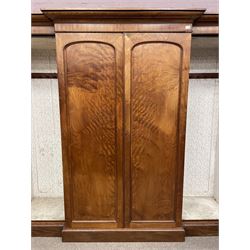 19th century figured mahogany quadruple breakfront press wardrobe, projecting cornice with banded frieze over arch panelled doors, the interior fitted with three sliding trays over two short and three long graduating drawers with recessed brass handles, flanked by two hanging cupboards with hooks