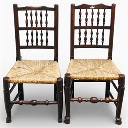 Set of five 19th century elm spindle back chairs, with shaped crest rails above double rows of turned spindles, rush seats, turned legs joined by stretchers supported on turned pad feet