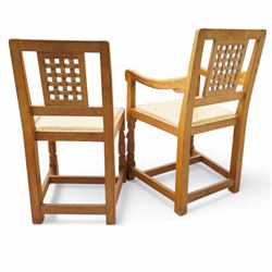 Mouseman - set of six (4+2) oak dining chairs, pierced and carved lattice back over leather upholstered seat, on octagonal front supports united by stretchers, carved with mouse signature, by the workshop of Robert Thompson, Kilburn