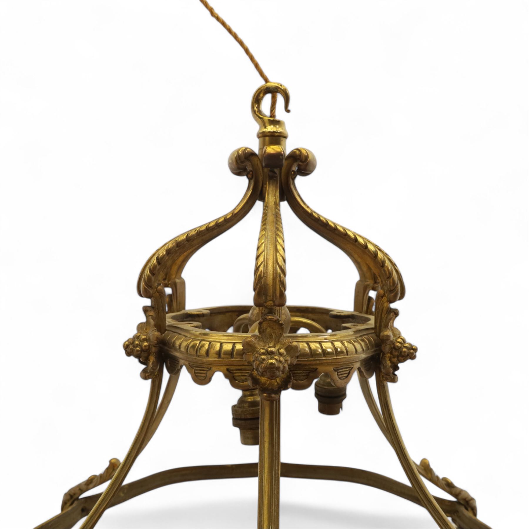Late Victorian gilt bronze neoclassical style open chandelier, open crown form suspended chandelier with hook finial and downward sweeping reeded and scrolled arms forming a canopy with six acanthus decorated ribs, lower section outward curved ribs forming a circular hoop detailed with fluted ornament and small foliate clasps, wired for electricity 