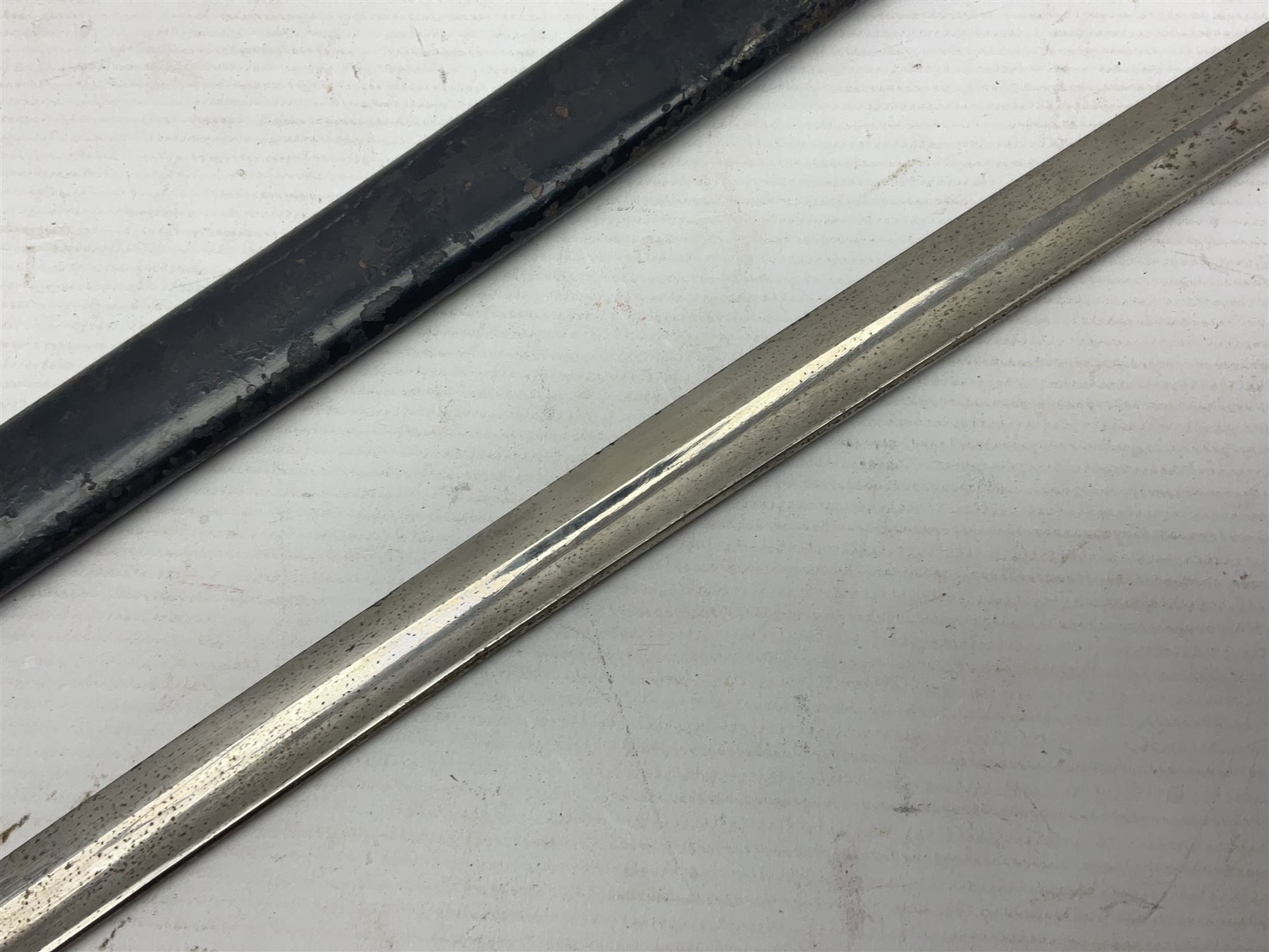 Prussian artillery officer's sword, with 80cm slightly curving fullered  blade, brass hilt with D-shaped langets, curving knucklebow, wire-bound black grip and leather finger loop; in black painted steel scabbard with single suspension loop