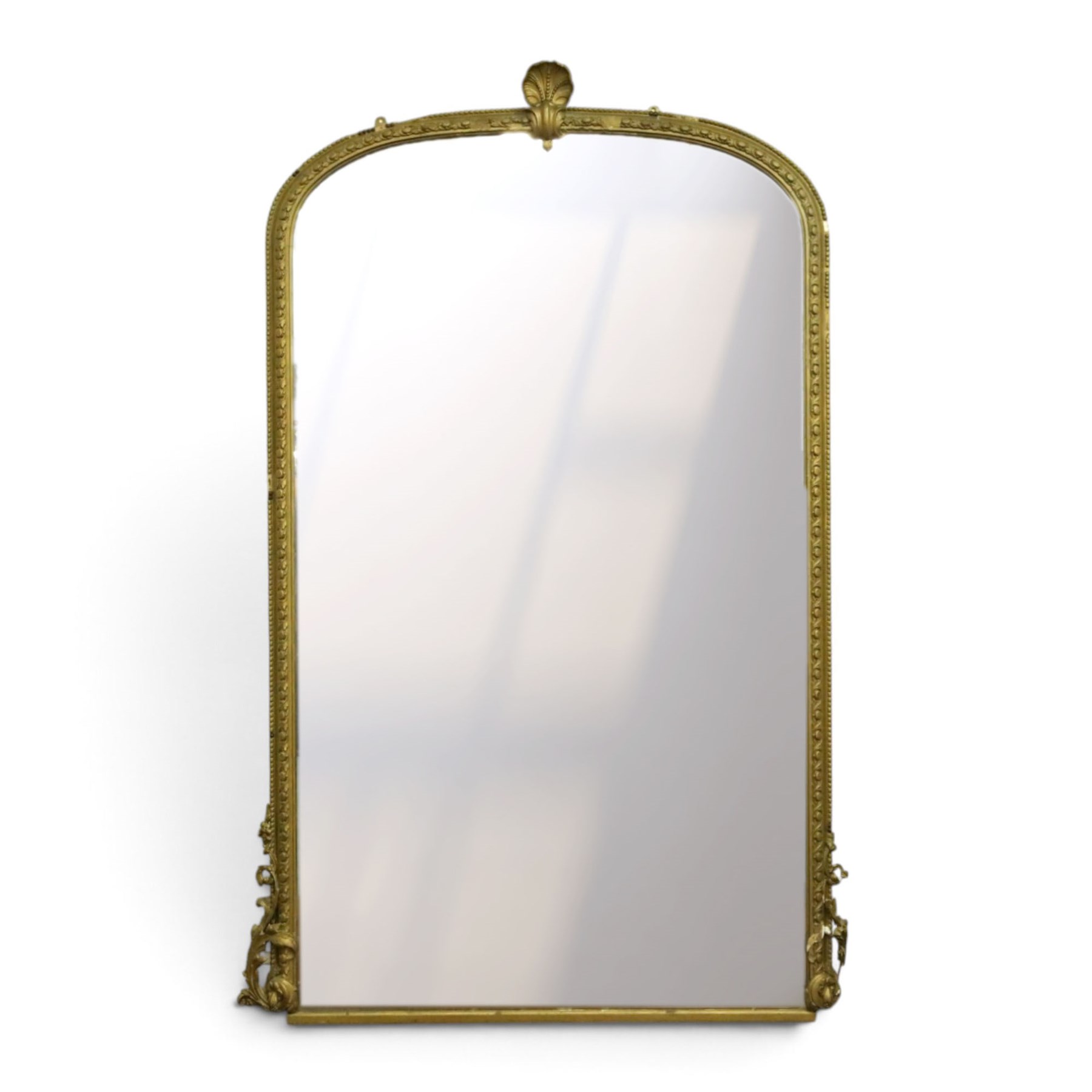 Large Country House late 19th century gilt framed overmantel mirror of arched form, the cartouche and scallop shell pediment over an egg-and-dart and beaded frame, the lower spandrels of scrolling foliate form with acanthus and flower head motifs