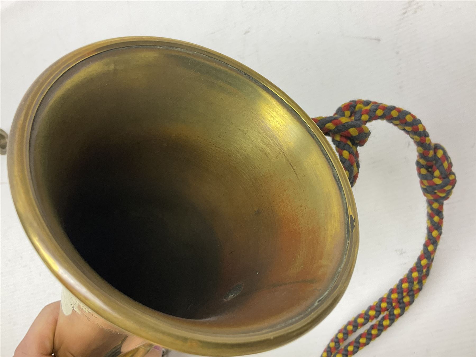Two military brass bugles by Mayers and Harrison Ltd. Manchester each with crows foot mark and dated 1966; both with multi-coloured cord and tassels, longest 52.5cm (2)