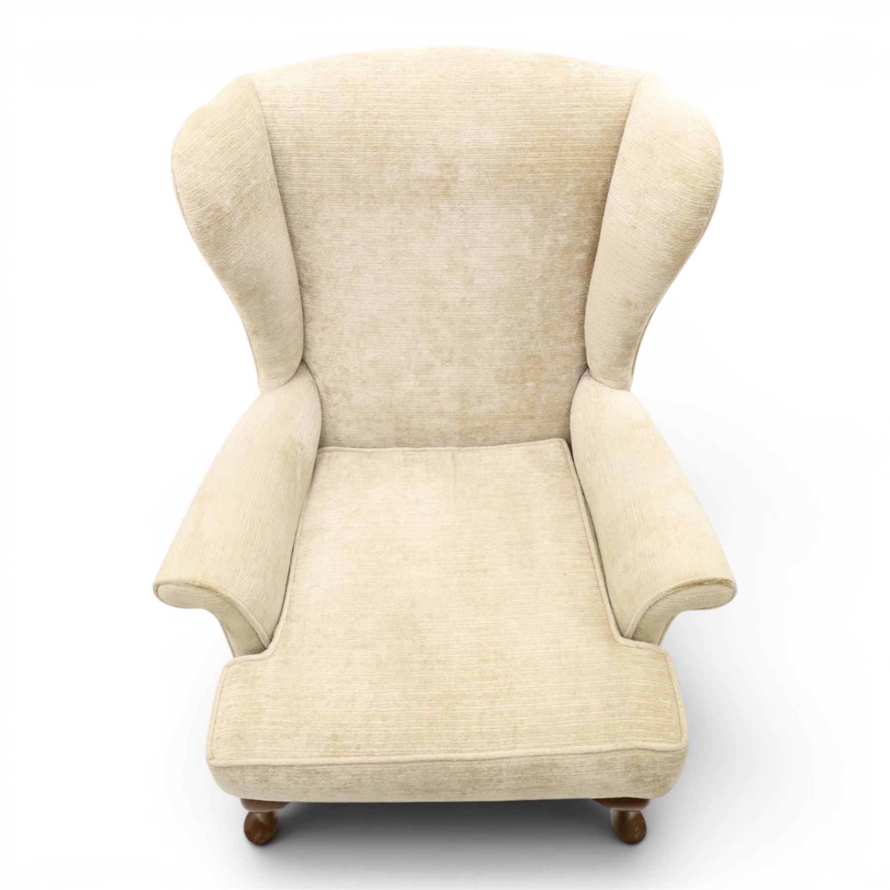 Parker Knoll - 'Hartley' lounge suite, comprising three wingback armchairs and two-seat settee, upholstered in cream fabric, shaped wing backs with scroll-over arms and loose seat cushions, on cabriole supports with pad feet wingbacks and settee

Armchairs: H 96cm, D 83cm, W 75cm